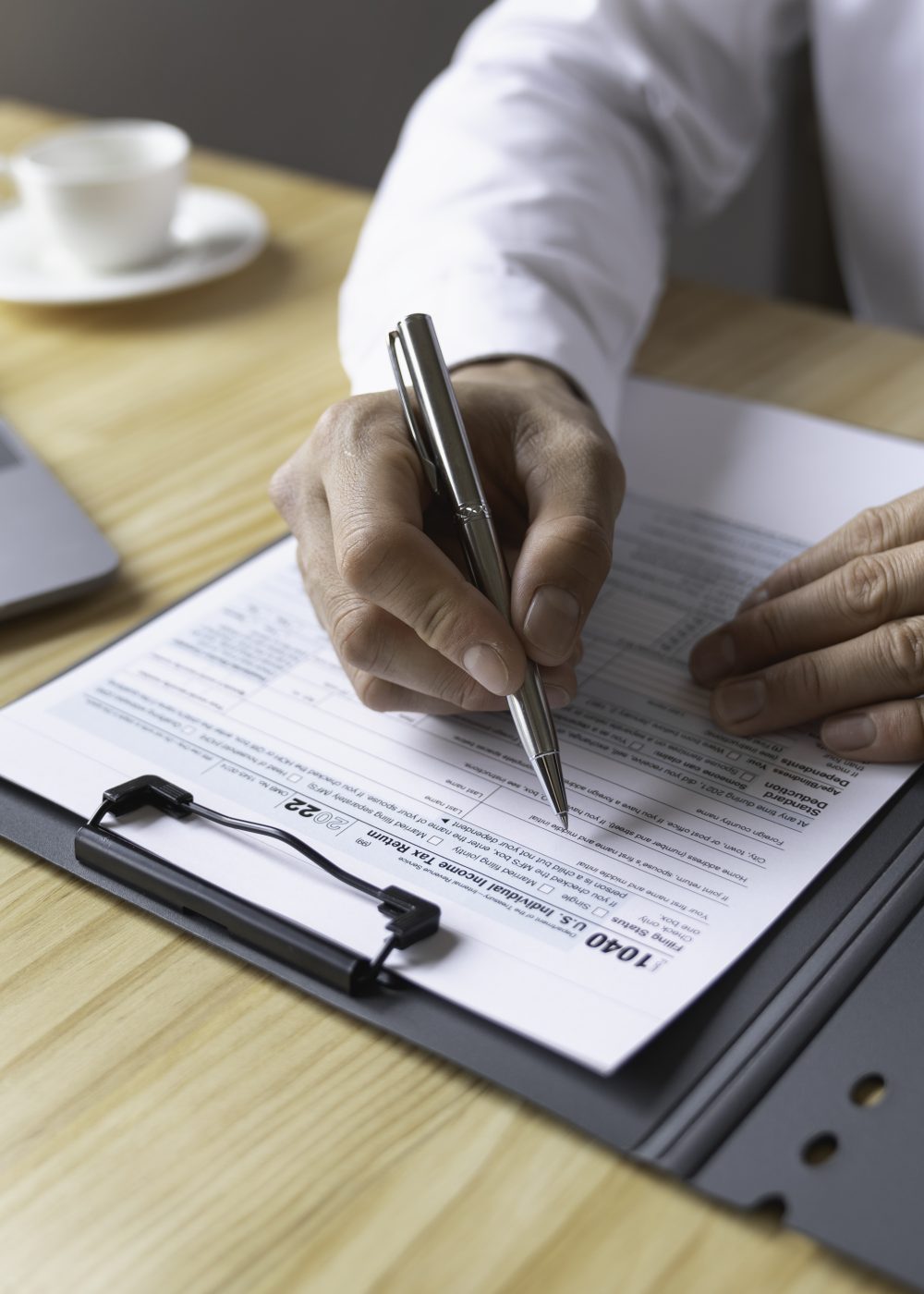 Individual Tax Return Forms on the table, An accountant working with US tax forms, Accountant calcul